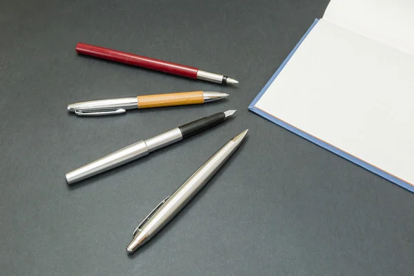 Set of pens with a book