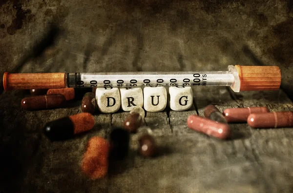 Old shabby filthy Photo drug pill on wooden table concept addict