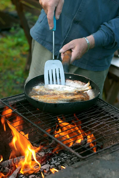 Fish frying in oil on the fire