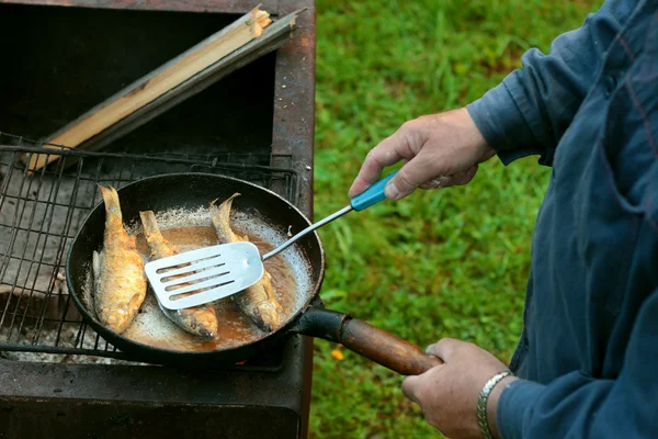 Fish frying in oil on the fire