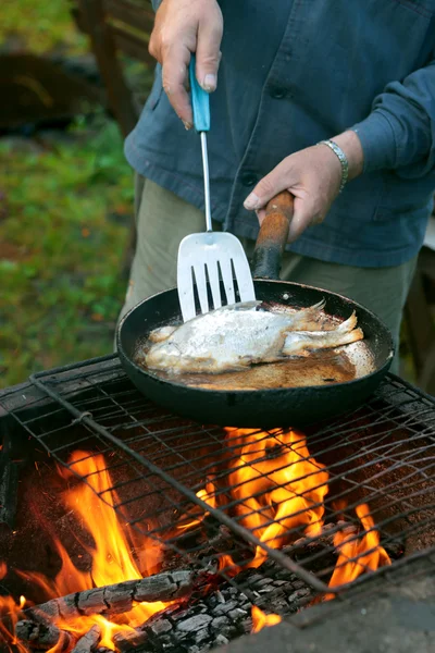 Fish frying in oil on the fire