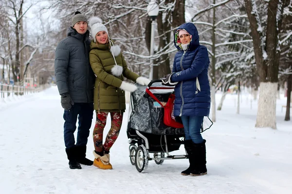 In the winter friends with a stroller