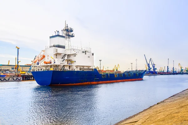 Cargo port. The cargo Ship blue color. Side view.
