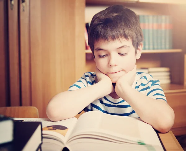 Seven years old child reading a book
