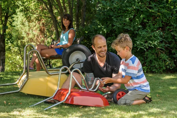 Boy with dad and wheelbarrow
