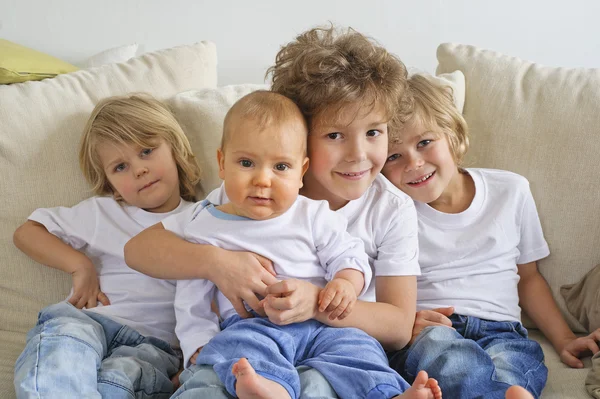 Four brothers on a sofa