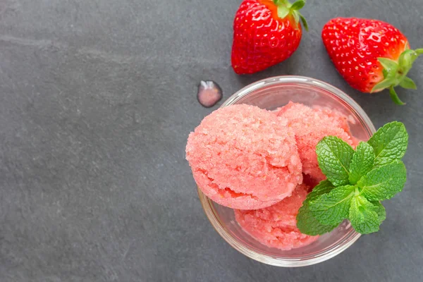 Homemade strawberry sorbet in glass, top view, copy space