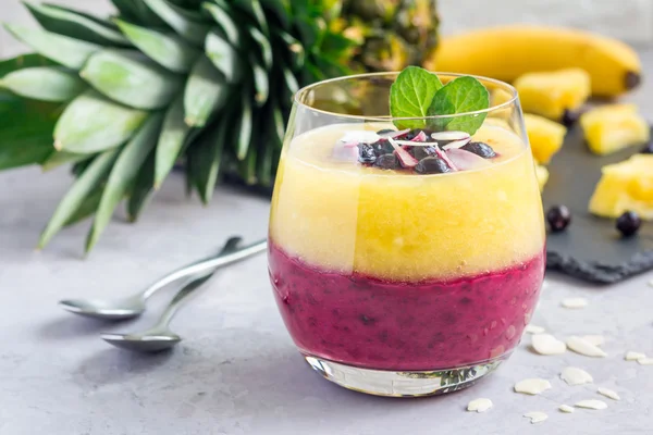 Two layer smoothie for breakfast in glass, horizontal