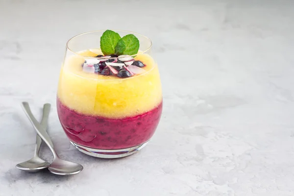 Two layer smoothie for breakfast in glass, horizontal, copy space
