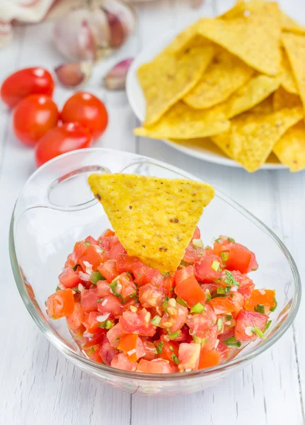 Bowl of fresh homemade salsa dip with nachos