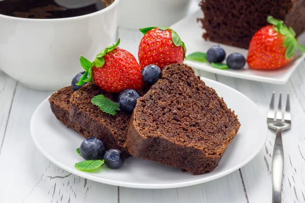 Freshly baked homemade chocolate banana bread (cake), decorated with berries
