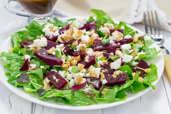 Salad with beets, feta cheese and walnuts, dressed with balsamic sauce