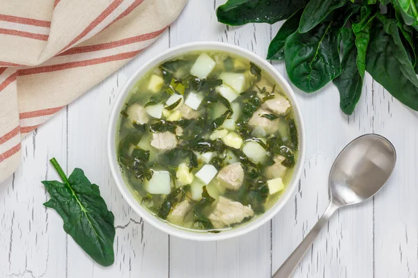 Healthy green soup with spinach meat, potato and egg (green borscht), top view