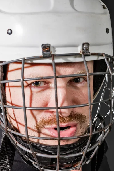 Portrait of brutal man in sports helmet