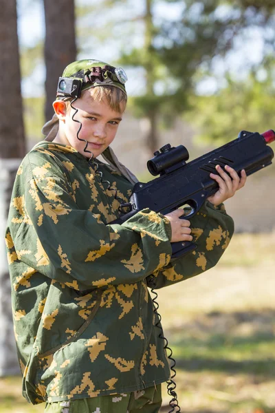 Boy with a gun playing laser tag