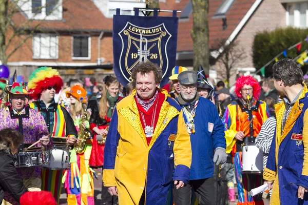 OLDENZAAL, NETHERLANDS - MARCH 6, 2011: People in colourful carnival dress during the annual carnival parade  in Oldenzaal, Netherlands.