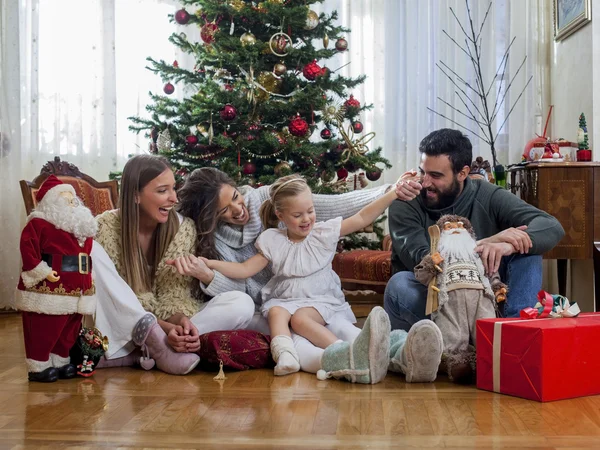 Happy family in front of Christmas tree