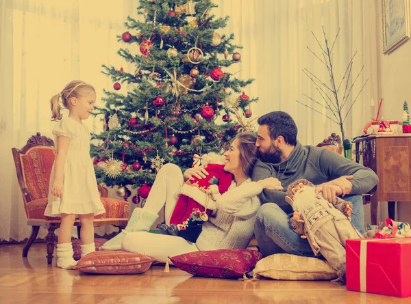 Happy family in front of Christmas tree