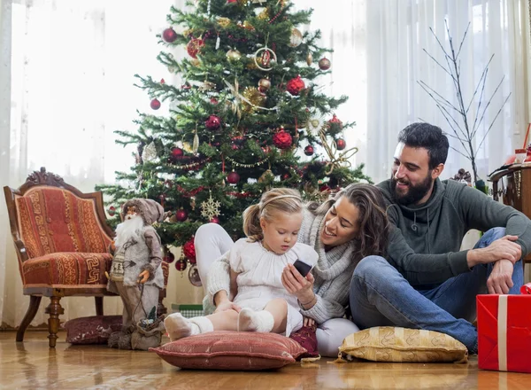 Happy family in front of Christmas tree