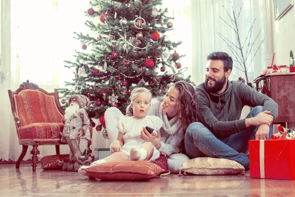 Happy family in front of Christmas tree