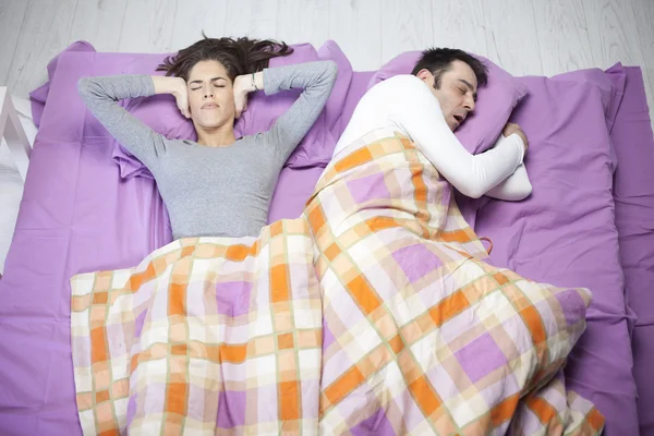 Man snoring and woman can not sleep