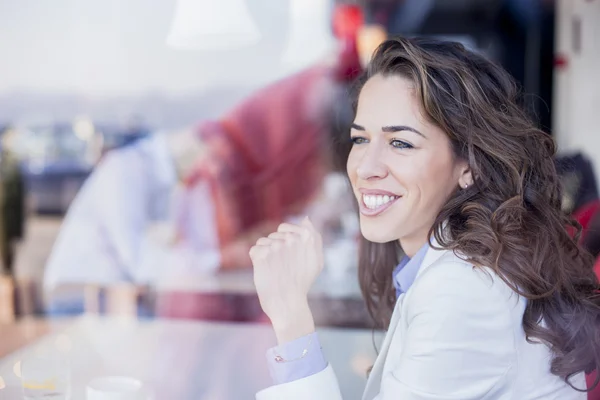 Businesswoman next to window in coffee shop