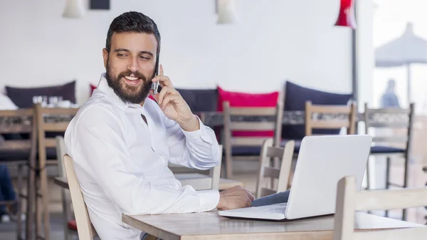 Businessman talking on phone in restaurant