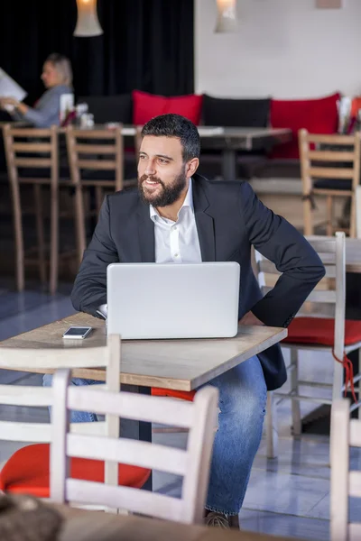 Businessman working on laptop in restaurant