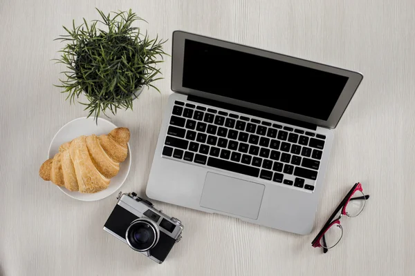 Laptop, smartphone, camera and glasses