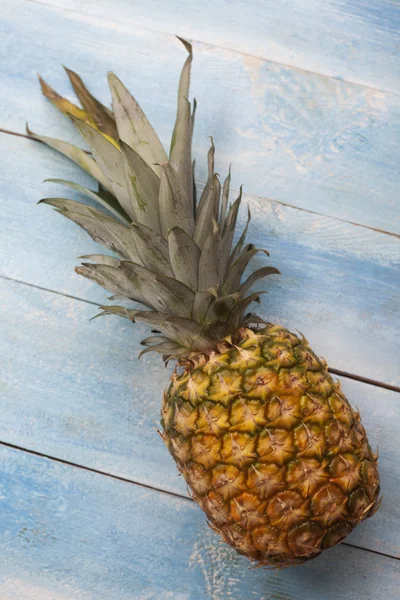 Pineapple on blue wooden board