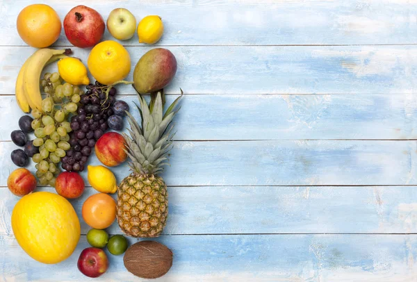 Fruits on a blue wooden board, top view