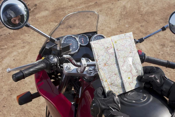 Motorcyclist looking at map