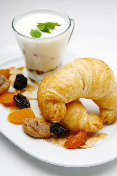 Croissant on plate with yogurt