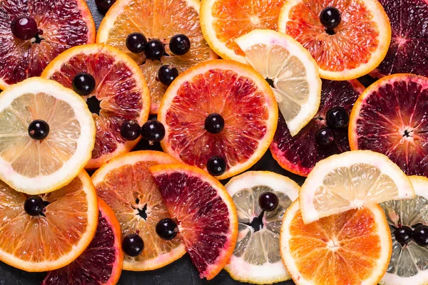 Fresh citrus fruits half cut, dark border background