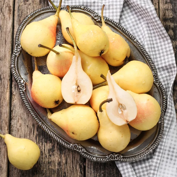 Ripe pears on vitage wooden table