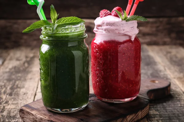 Healthy green fresh fruit and vegetable juice green and pink smoothie