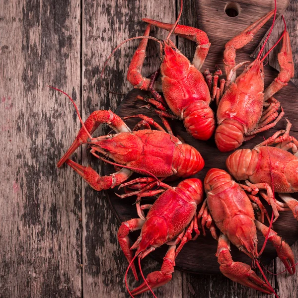 Fresh boiled crawfish on the old wooden background
