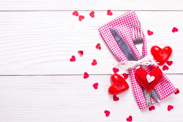 Festive table setting for Valentines Day on light wooden background