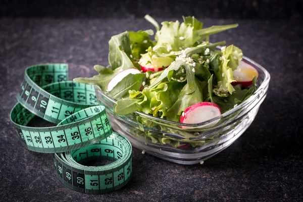 Diet concept, salad ingredients on black background . healthy food