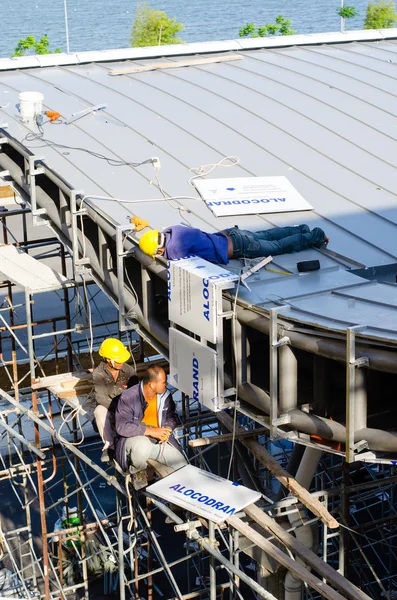 Foreign worker working on roof installation