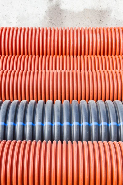 Construction orange and black plastic pipes