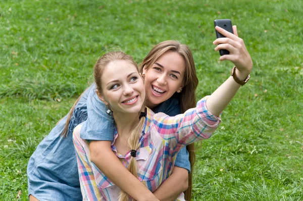 Two women friends doing selfie phone