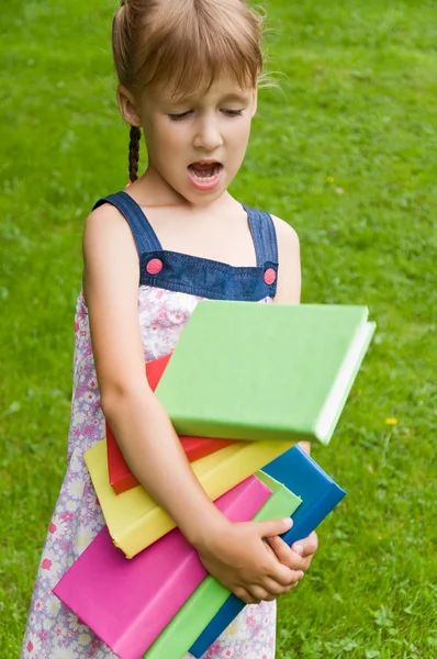 Little schoolgirl drops lot of books