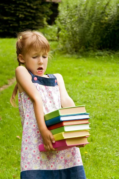 Little schoolgirl drops lot of books