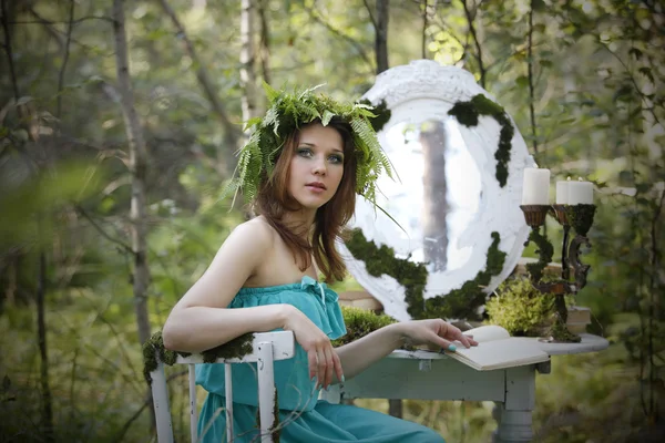 Beautiful model in the woods in a vintage scenery