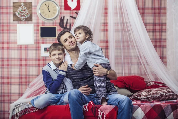 Father hugging son and daughter the children at home in comforta