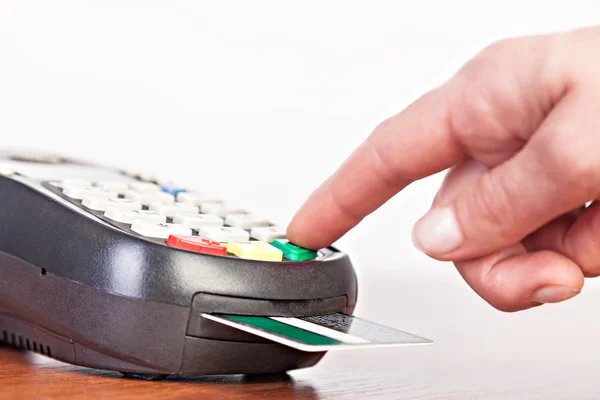 Human hand  using payment terminal, credit card reader.