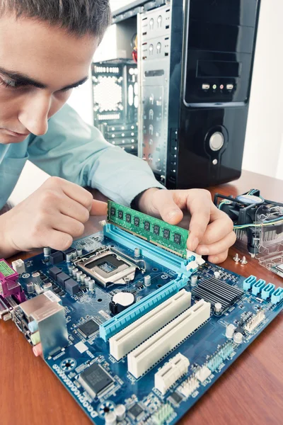 Technician repairing computer hardware in the lab.