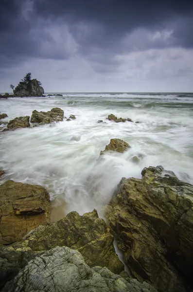 Beautiful beach with rock hitting by waves. soft focus due to long exposure