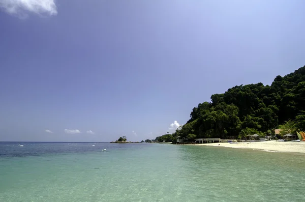 Scenic sea view of the Kapas Island at Terengganu, Malaysia. Clear sea water and blue sky background. Rocky island and cloudy sky at sunny day